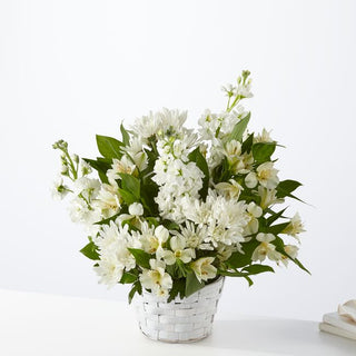 Sympathy flower basket with white roses and greenery – Hand-delivered to homes in Toronto for funeral condolences.
