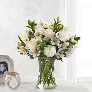 Elegant funeral flower vase featuring white roses and carnations for home or memorial services