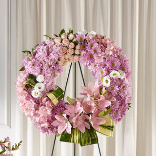 Tribute standing spray with pink lilies and soft delicate pink flowers for funeral delivery in GTA