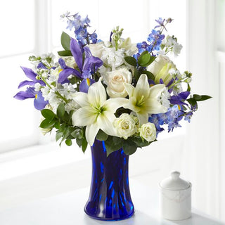 Elegant white and blue sympathy flowers arranged in a glass vase. Thoughtful condolence gift with delivery available in Vaughan and nearby.