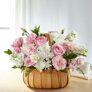 Send comfort with a pink and white sympathy flower basket featuring roses, lilies, and alstroemeria. Funeral and home delivery in Toronto available.