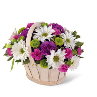 Bright purple, green, and white floral arrangement in a wooden basket, handcrafted by Yunza Florist Toronto