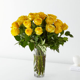 Elegant bouquet of 24 yellow roses arranged in a tall clear glass vase, available for same-day flower delivery in Toronto and the GTA