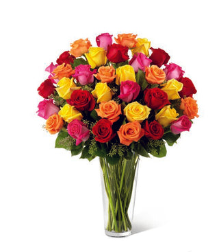 Fresh mixed roses in vibrant shades, presented in a crystal-clear vase