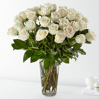 Elegant bouquet of 36 premium white roses arranged in a clear vase with lush foliage – same-day Toronto florist