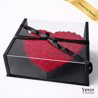 Heart-shaped arrangement of red preserved roses in a black luxury box