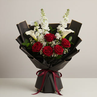 Experience luxury with the Crimson Elegance Bouquet — red roses, white  lilies, and white Stocks wrapped in sleek black paper and satin ribbon. Yunza Florist Toronto