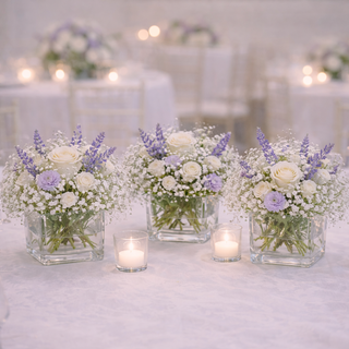 Elegant lavender and white wedding table centerpieces with roses and baby’s breath in glass vases at Toronto wedding reception