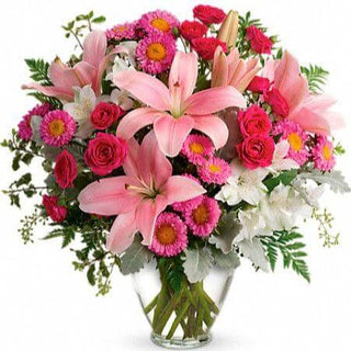 Pink Lilies, Pink Daises, Pink Roses.. Show her how much she means to you by sending this beautiful arrangement. We offer delivery to Edmonton and the surrounding area