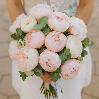 Bridal bouquet of soft pink and white peonies with eucalyptus greenery, handcrafted by Toronto florist Yunza Florist. Ideal for weddings and same-day delivery in Toronto and the GTA.