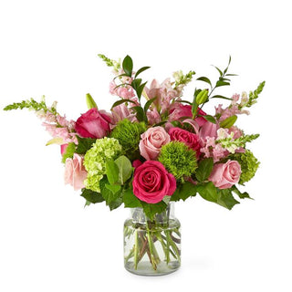 Hand-tied pink flower bouquet with roses and lilies, styled for elegant celebrations