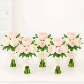 Set of elegant bridesmaid bouquets made with blush pink and white peonies, accented with greenery and ivory ribbon. Perfect peony wedding flowers for bridesmaids in Toronto.
