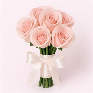 Bridesmaid bouquet with 6 soft pink roses tied with a white satin ribbon on a white background, elegant wedding flowers by Yunza Florist Toronto.