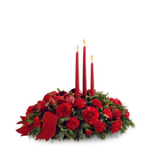 Elegant Christmas centerpiece with red roses, carnations, and greenery featuring three red candles