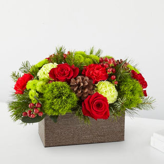 Seasonal Christmas centerpiece with fresh roses, pine accents, and greenery, ideal for holiday celebrations