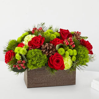 Traditional Christmas floral box with red roses, green mums, and pine needles, designed by Yunza Florist