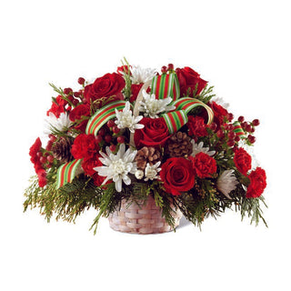 Winter-themed flower arrangement with rich colors and fresh greens