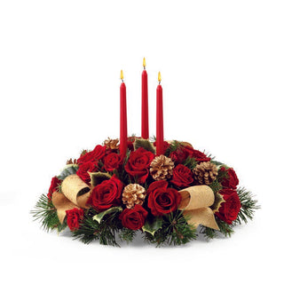 Red rose and evergreen Christmas centerpiece with candles for festive home décor