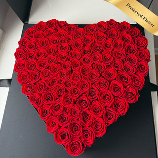 Heart-shaped arrangement of red preserved roses in a black luxury box