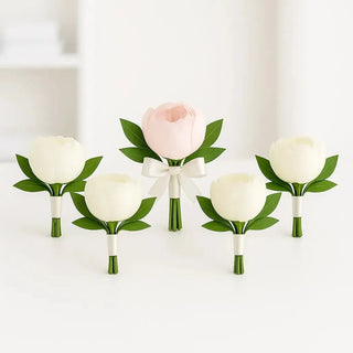 Set of six peony boutonnieres including one for the groom and five for the groomsmen. Elegant pink and white peonies with greenery and ivory ribbon wrap, handcrafted wedding flowers available in Toronto.
