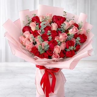Luxury red and blush rose bouquet with pink wrapping for Valentine’s Day flower delivery in Toronto
