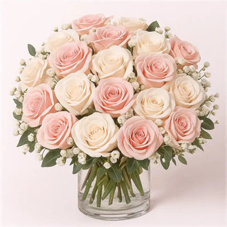 Romantic rose arrangement of soft blush pink and white roses in a glass vase by Yunza Florist Toronto