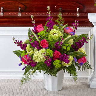 Fresh floral floor basket arrangement with pink roses for funeral sympathy
