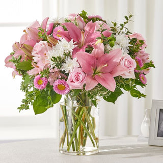 Sympathy flower arrangement with pink lilies and white roses – Delivered to Durham homes with care.
