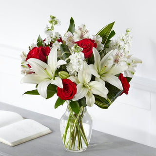 Fresh sympathy vase with red roses, white lilies, and greenery – flower delivery Toronto