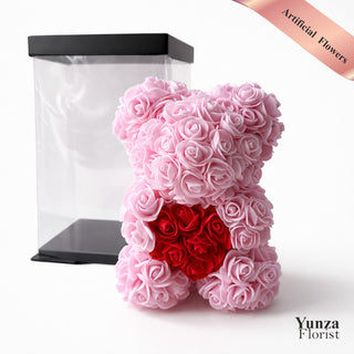 Pink eternal rose teddy bear with red heart made from artificial flowers in a clear gift box, luxury Valentine’s Day and Mother’s Day gift
