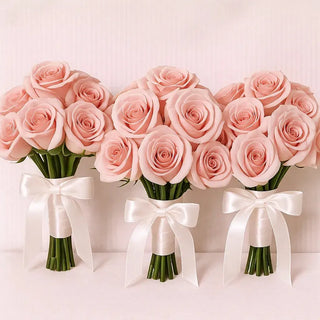 Wedding bouquet with six blush pink roses and white satin bow, perfect for bridesmaids and maid of honor.