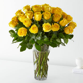 Classic yellow rose bouquet with lush greenery in a clear glass vase, hand-arranged by Yunza Florist for local delivery