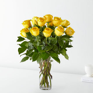 Bright yellow roses in a tall vase, symbolizing friendship, joy, and celebration, perfect for birthdays and anniversaries in Toronto.