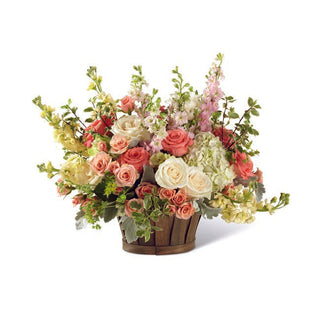 Elegant rose and hydrangea basket arrangement in soft pink, cream and green tones
